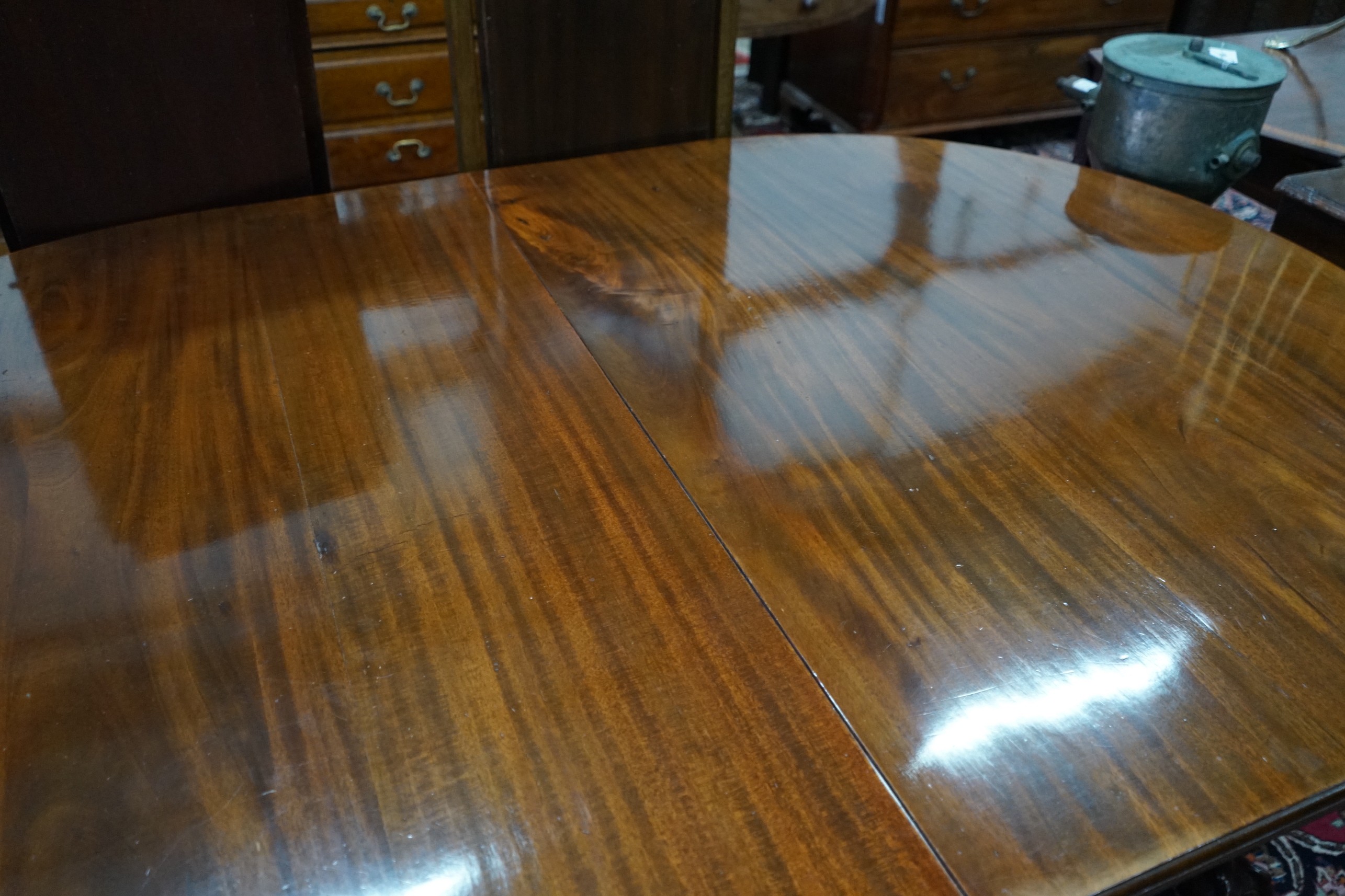 A 1920's mahogany extending dining table on ball and claw feet, with three spare leaves, 296cm extended, width 120cm, height 73cm